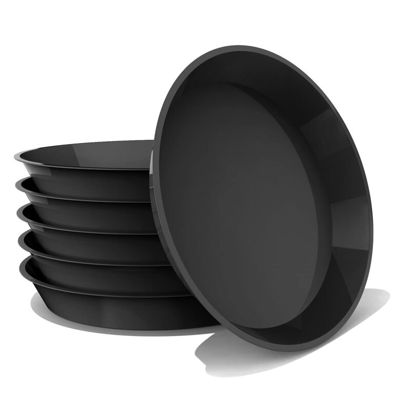 Stack of black plant saucers, one leaning against the stack