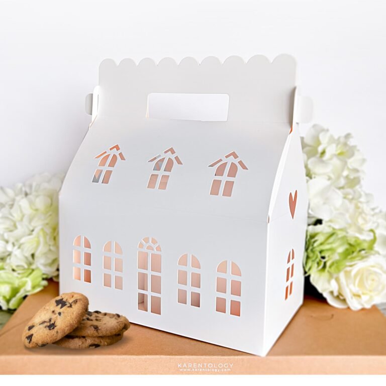 White house-shaped gift box with cookies, flowers, and a handle